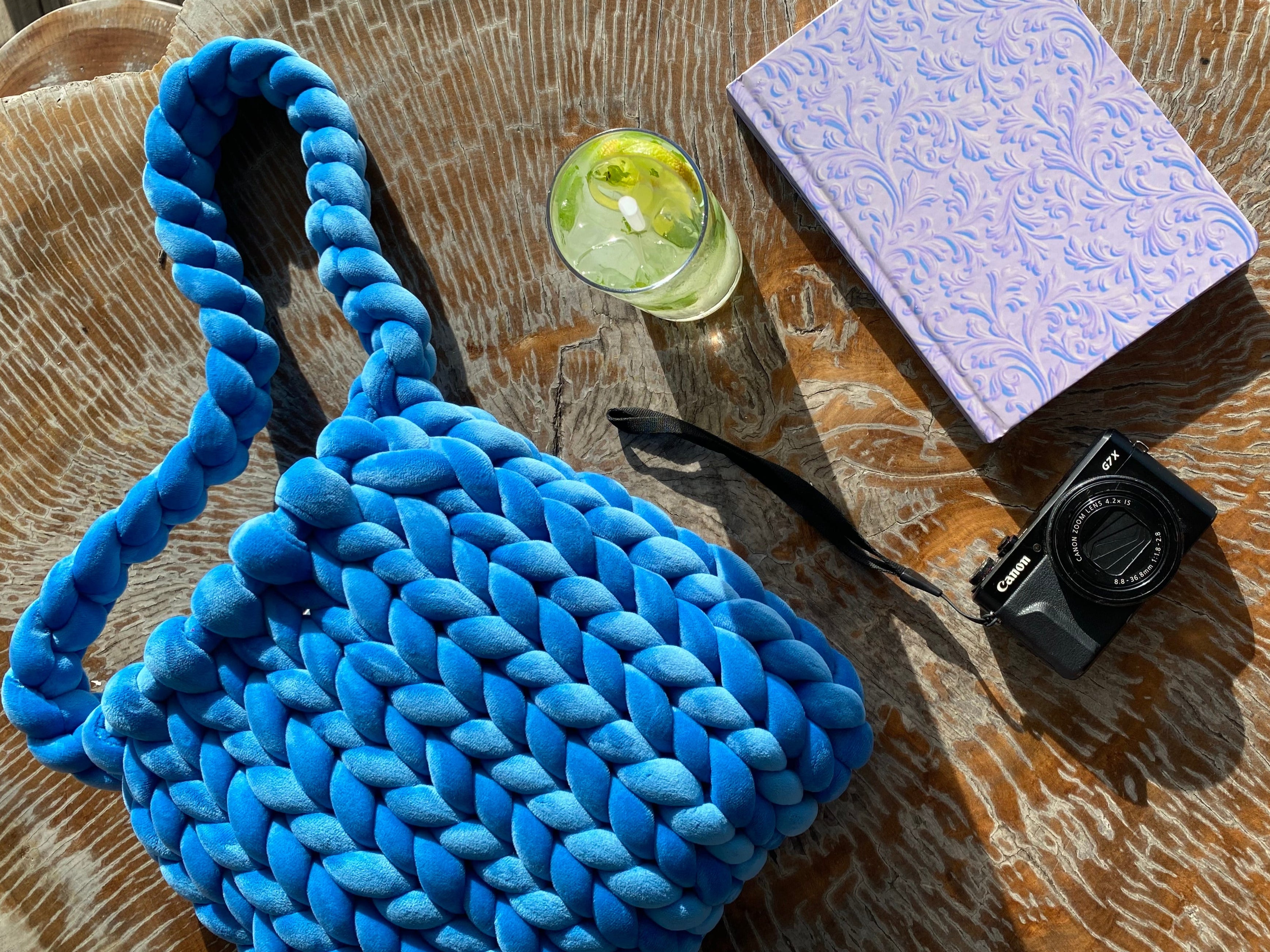 ocean blue sustainably handmade bag made out of chunky velvet yarn and a hardcover journal that is pretty and purple and blue for the junk journal girls who like to write and craft