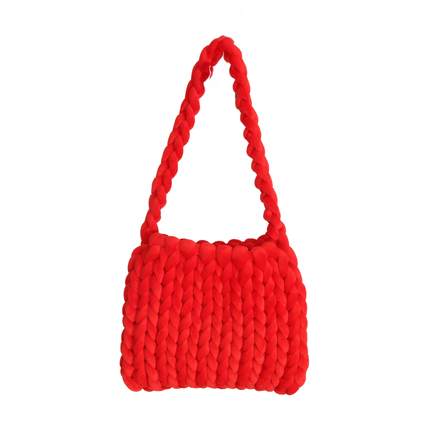 A red, hand crocheted tote bag with a chunky texture, displayed against a white background.