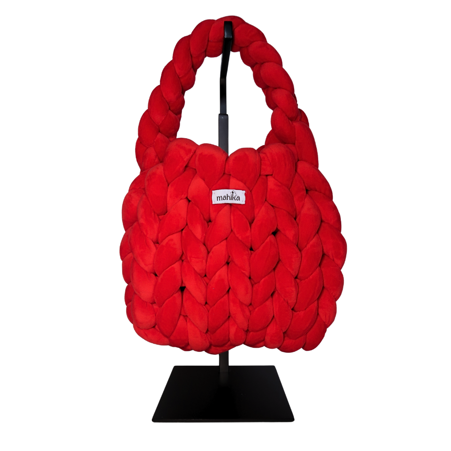 bright Red woven and finger crocheted handbag on a black stand with 'Malika' branding.